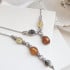 Collana con ambra ovale multicolore, in argento 925 rodiato