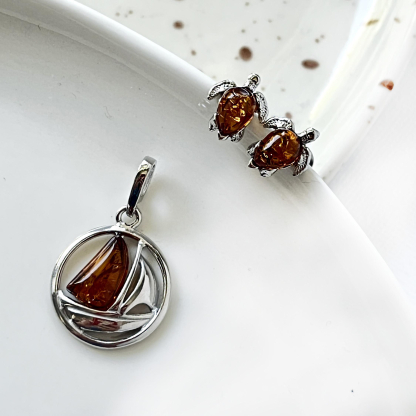 Natural irregular cognac Baltic amber boat pendant, rhodium-plated 925 silver