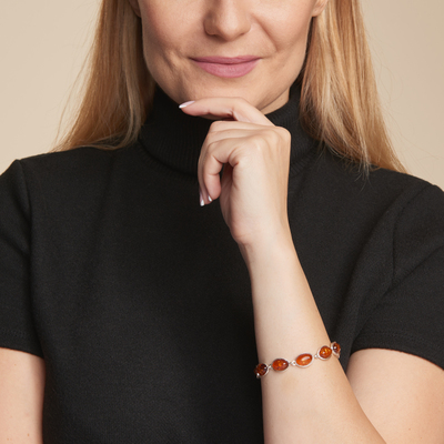 Wholesaler of jewelry and accessories - Bracelet with natural oval cognac amber, in rhodium silver 925/1000, length 18 cm